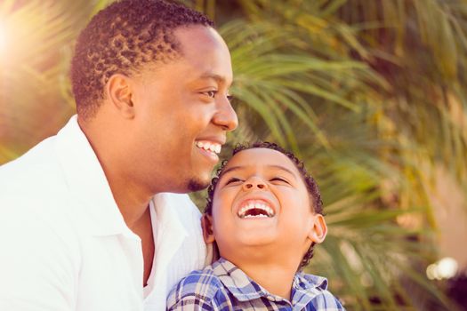 Mixed Race Son and African American Father Playing Outdoors Together.