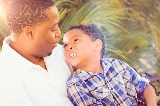 Mixed Race Son and African American Father Playing Outdoors Together.