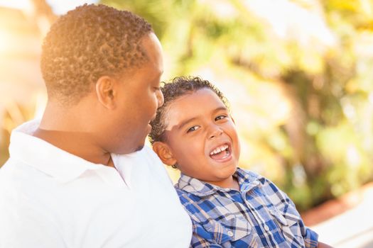 Mixed Race Son and African American Father Playing Outdoors Together.