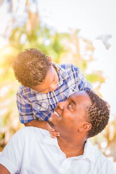 Mixed Race Son and African American Father Playing Outdoors Together.