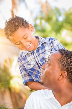 Mixed Race Son and African American Father Playing Outdoors Together.