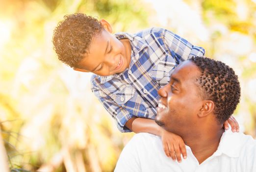 Mixed Race Son and African American Father Playing Outdoors Together.