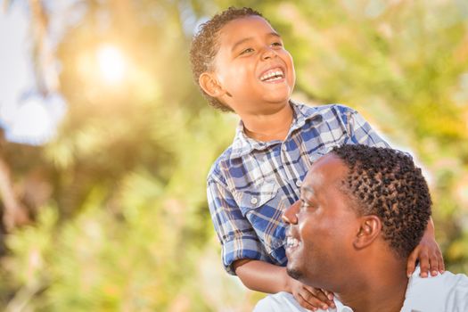 Mixed Race Son and African American Father Playing Outdoors Together.