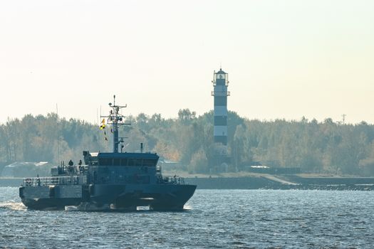Small grey military ship moving from Baltic sea
