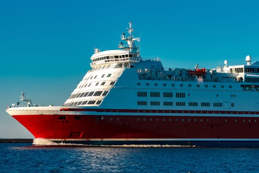 Red cruise liner. Large passenger ferry underway
