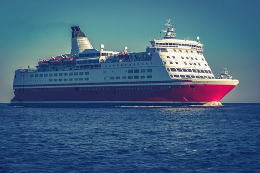Red cruise liner. Large passenger ferry underway