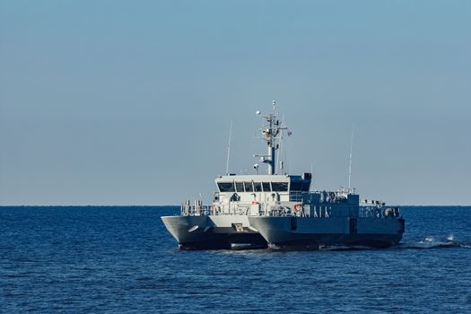 Small grey military ship moving from Baltic sea