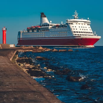 Red cruise liner. Large passenger ferry underway