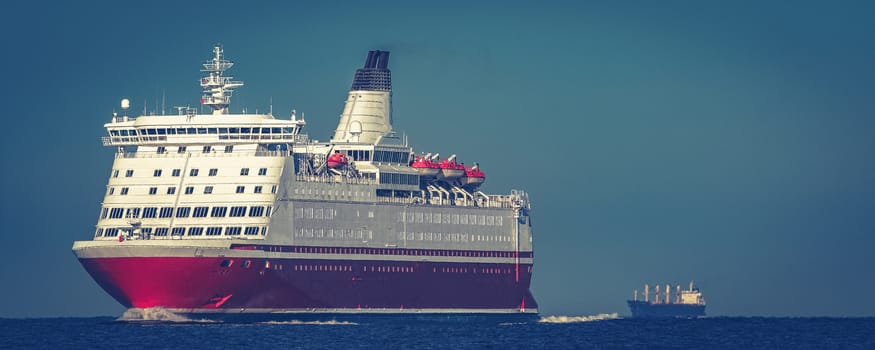 Red cruise liner. Large passenger ferry underway