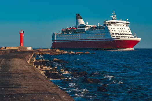 Red cruise liner. Large passenger ferry underway