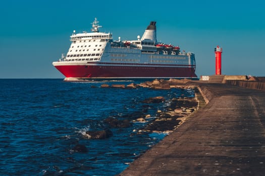 Red cruise liner. Large passenger ferry underway