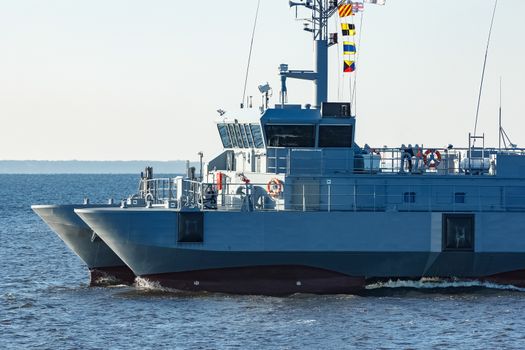 Small grey military ship moving from Baltic sea