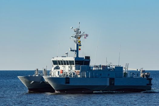 Small grey military ship moving from Baltic sea
