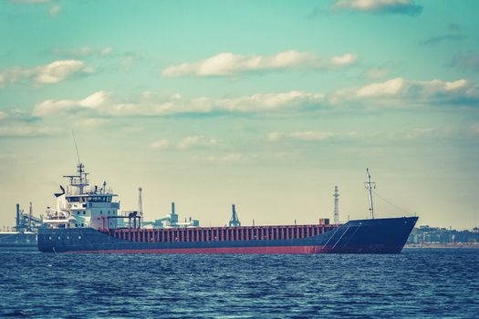 Blue cargo ship moving to the cargo port