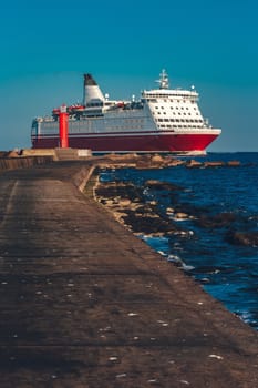 Red cruise liner. Large passenger ferry underway