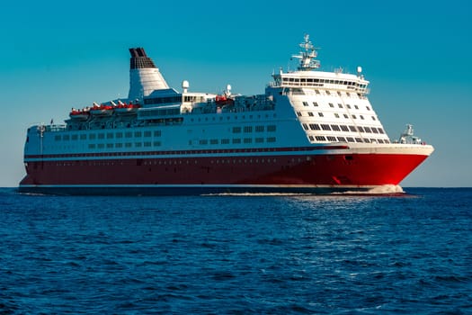 Red cruise liner. Large passenger ferry underway