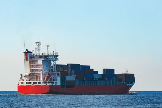 Red container ship sailing to the Baltic sea