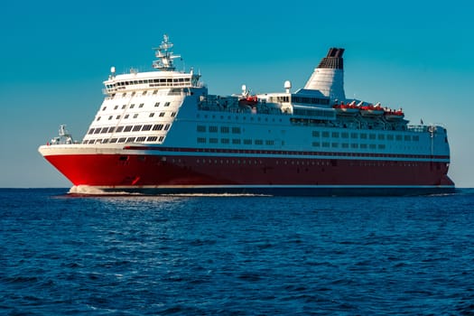 Red cruise liner. Large passenger ferry underway