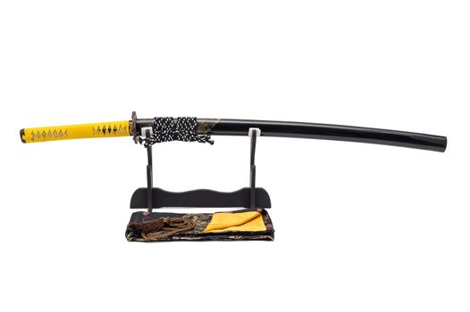 Japanese sword with yellow leather cord wrapped on handle and scabbard with ray skin on stand white background, black silk bag at front.