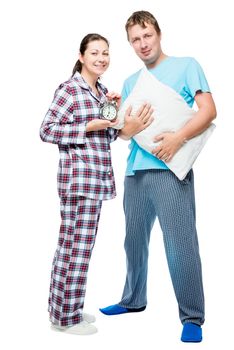 Husband and wife in pajamas on white background posing in studio