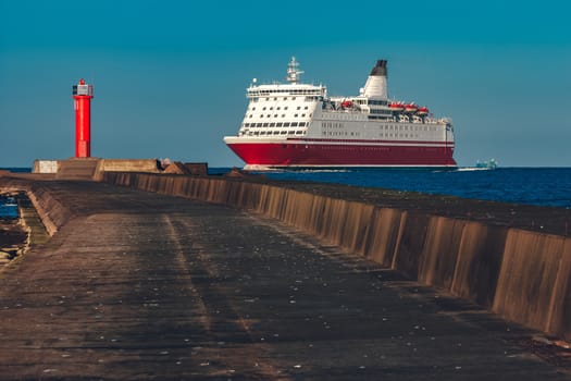 Red cruise liner. Large passenger ferry underway