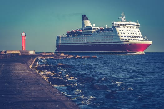 Red cruise liner. Large passenger ferry underway