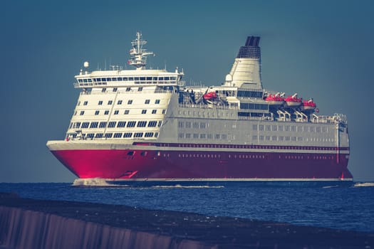 Red cruise liner. Large passenger ferry underway