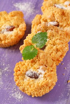 Small almond cookies on purple background