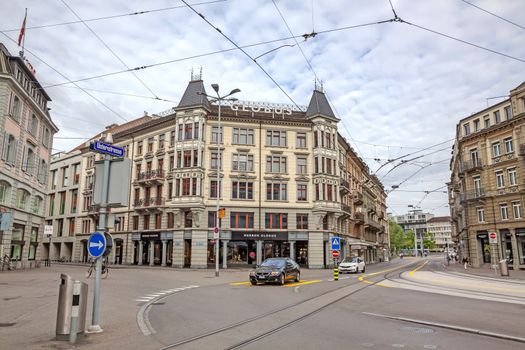 Zurich, Switzerland - June 10, 2017: Inner-city of Zurich with mall named globus in street Usteristrasse. Old buildings, tram rails in front.