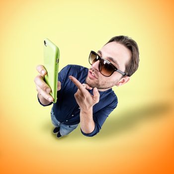 latin lover make a funny face, and take a self portrait with his smart phone