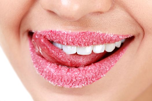 Closeup of woman's lips covered with sugar. Toothy smile