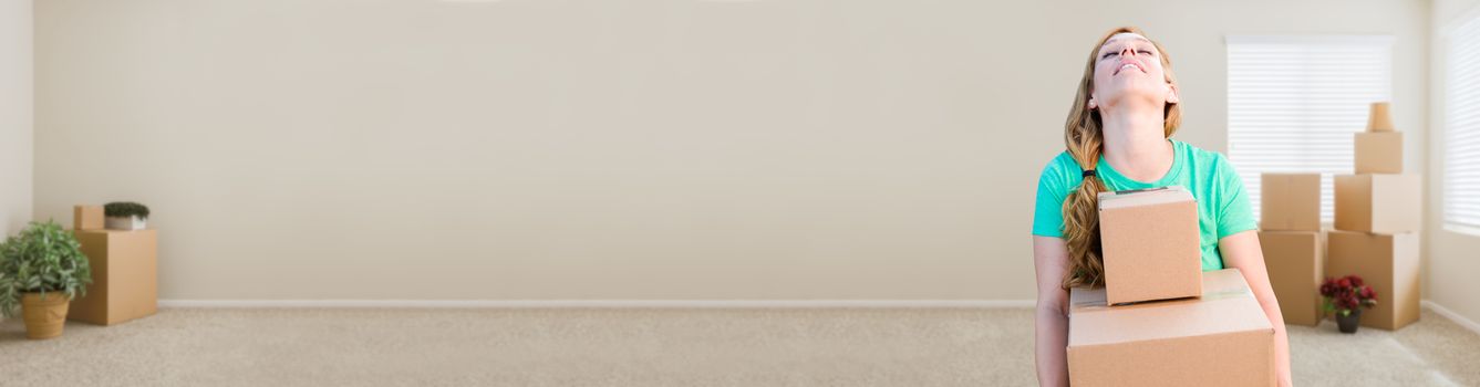 Banner of Tired Young Adult Woman Holding Moving Boxes In Empty Room In A New House.