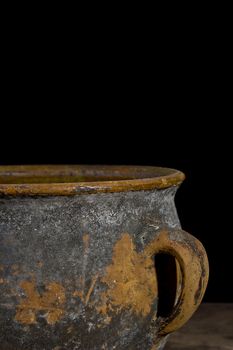 Fragment of antique pottery on a black background