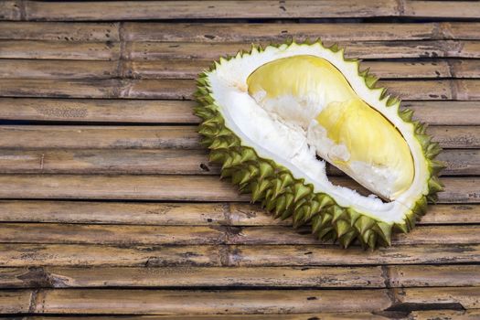 Fresh Cut Durian pulp on bamboo table top background, king of fruit in Thailand, smelly fruit in the world