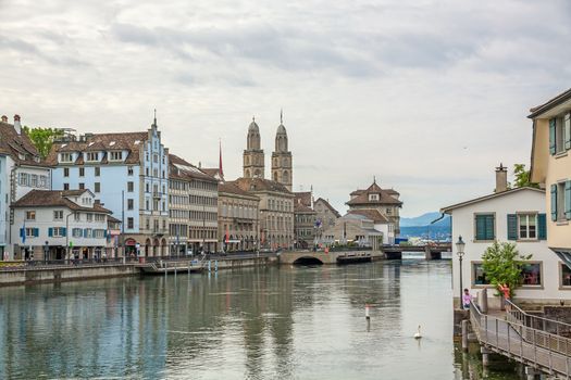 Zurich, Switzerland - June 10, 2017: Downtown view of Zurich from bridge Rudolf-Brun-Brucke, Grossmunster, town hall and river Limmat in front.