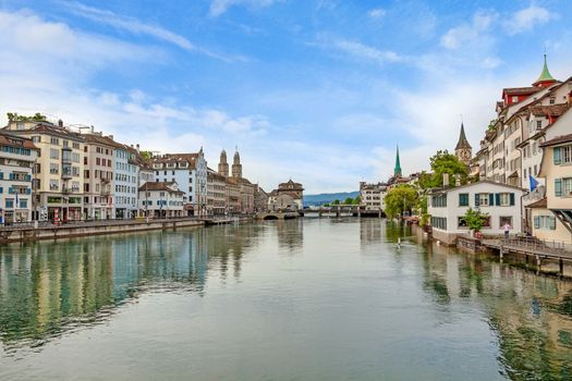 Zurich, Switzerland - June 10, 2017: Zurich downtown, view of Grossmunster, Fraumunster and St. Peter. Limmatquai (left), river Limmat in front.