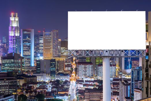 Blank billboard for advertisement in city downtown at night.