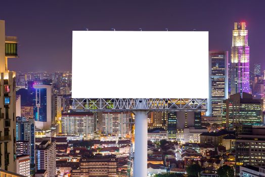 Blank billboard for advertisement in city downtown at night.