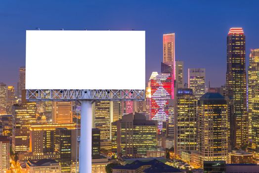 Blank billboard for advertisement in city downtown at night.