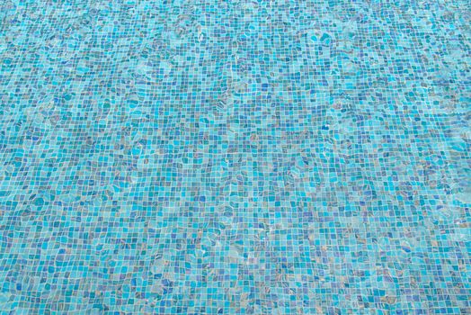 blue swimming pool with sunny reflections abstract for background.