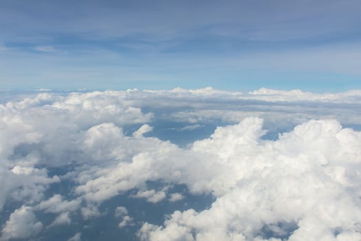 Blue sky and Clouds as seen through window of aircraft.