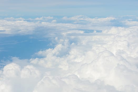 Blue sky and Clouds as seen through window of aircraft.