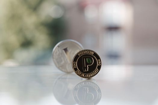 Digital currency physical gold peercoin coin near silver litecoin