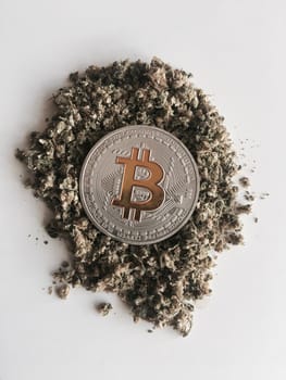 Digital currency physical silver bitcoin coin on the weed