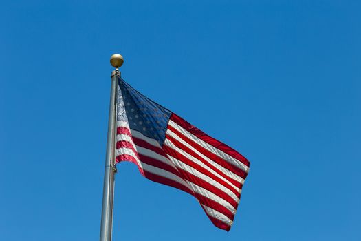 The United States flag on a flag pole.