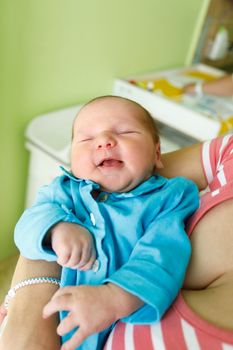 newborn baby infant in the hospital, the first hours of the new life, one days after birth