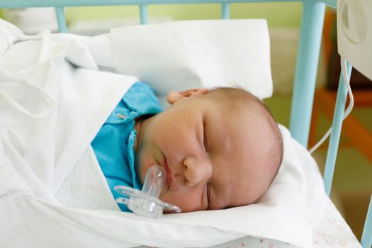 newborn baby infant in the hospital, the first hours of the new life, one days after birth