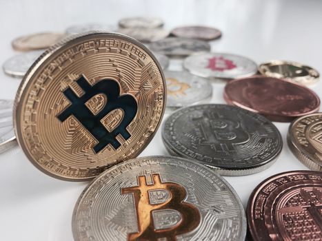 Cryptocurrency physical silver and gold bitcoin coins on the table.
