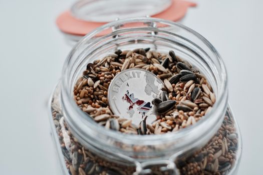 Silver brexit physical coin with British map in jar with seeds