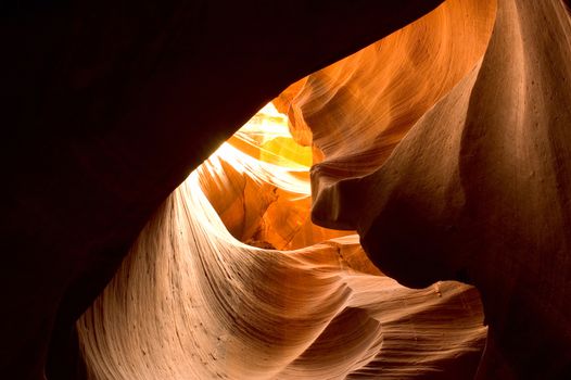 Antelope Canyon canyon curves. Sunlight shining through the curved canyon walls of Antelope Canyon. Plenty of room for copy in the shadows.